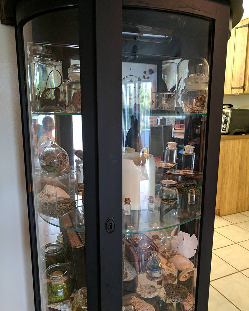 black curio cabinet with glass shelves
