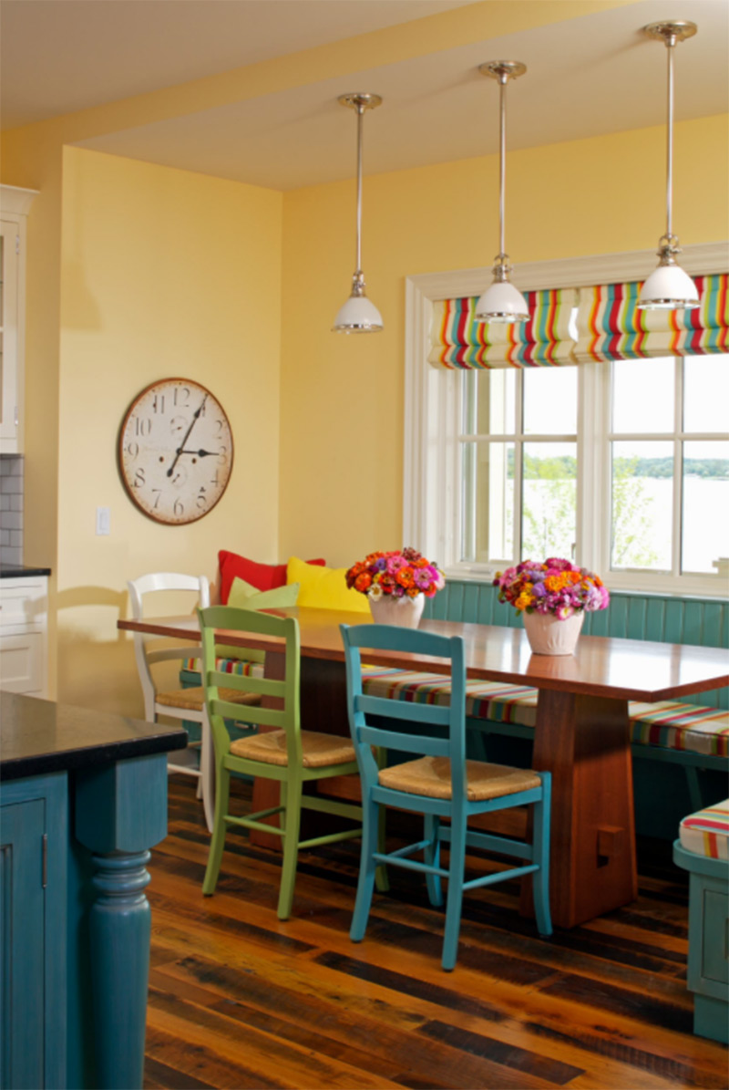 Bright yellow dining room with striped curtains